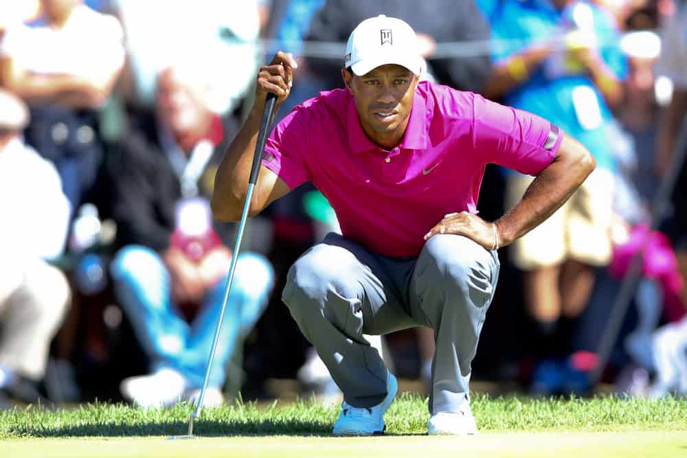 Tiger Woods lines up a putt