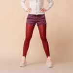 Women in red stockings, sneakers, purple denim shorts