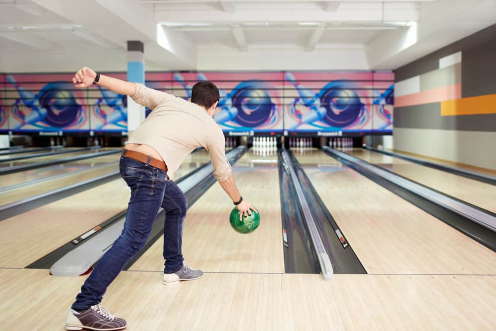 Young man playing bowling