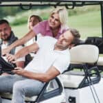 friends riding golf cart