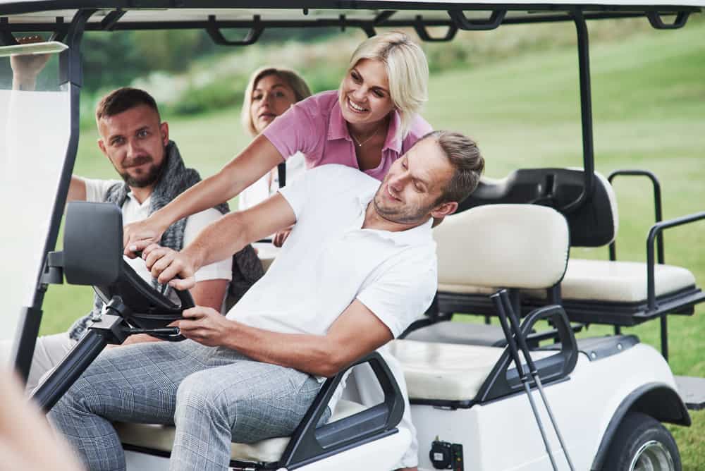 friends riding golf cart