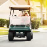 man riding a golf cart