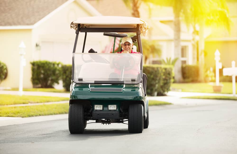 man riding a golf cart