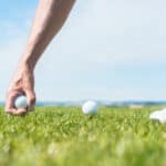 professional male player taking a golf ball