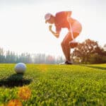 putting golf ball on the green
