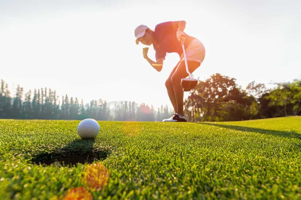 putting golf ball on the green