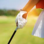 Closeup of a golfers hand holding a golf club