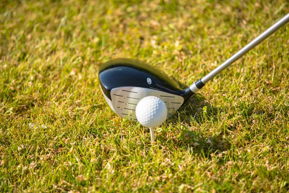 Man Using Fairway Wood Playing Golf in summer