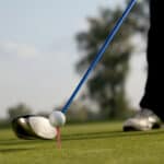 Person playing golf with driver
