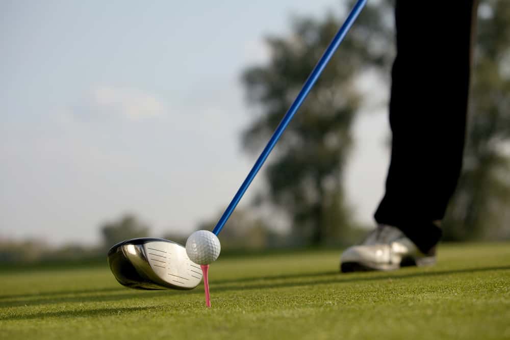 Person playing golf with driver