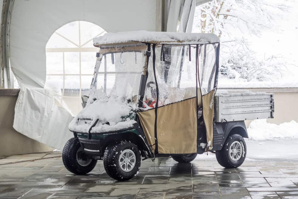 Snow-covered golf cart