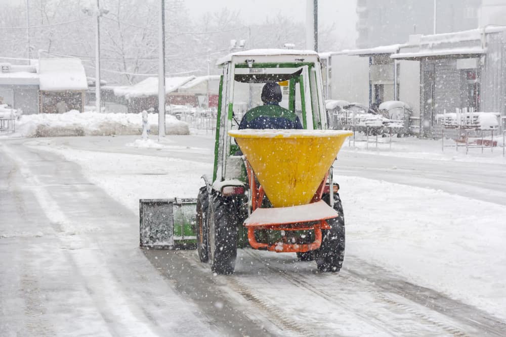 Snow plow removing snow