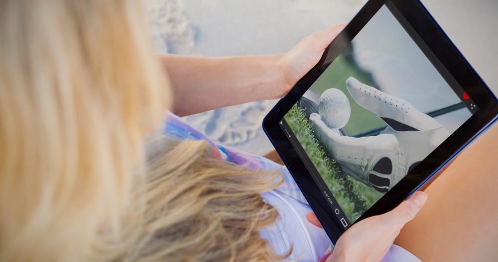 Woman on beach using tablet pc