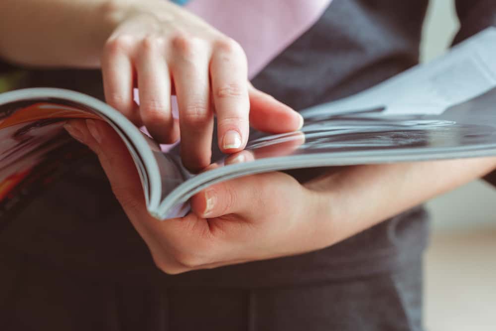 Woman reading magazine at home