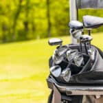 golf clubs on fresh green golf course