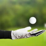Golfer Wearing Golf Glove throw ball
