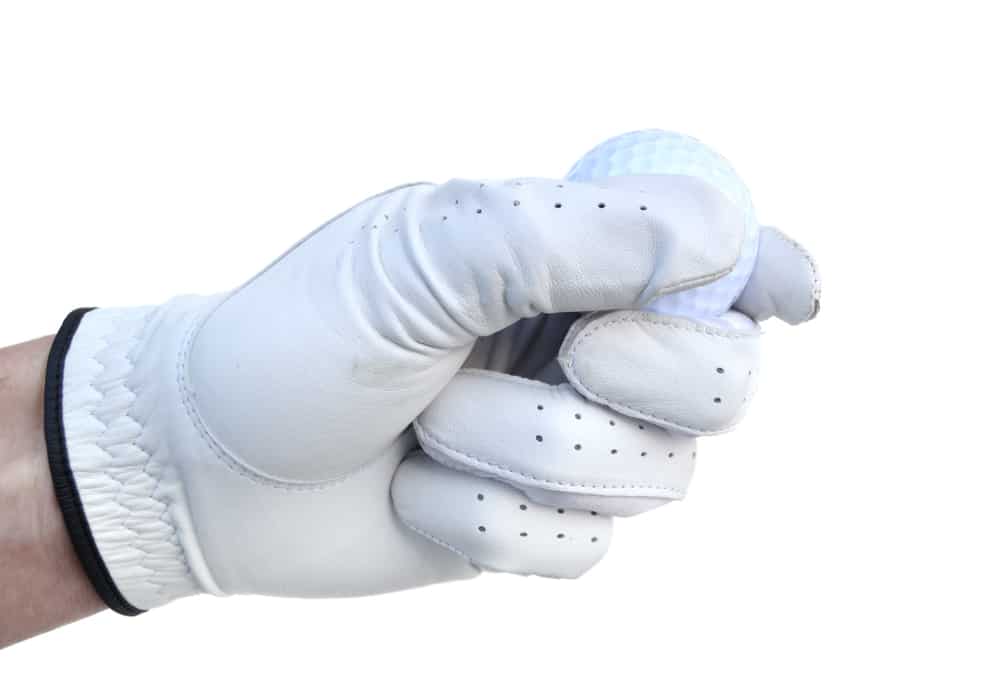 Golfer wearing Golf Glove Holding a Golf Ball