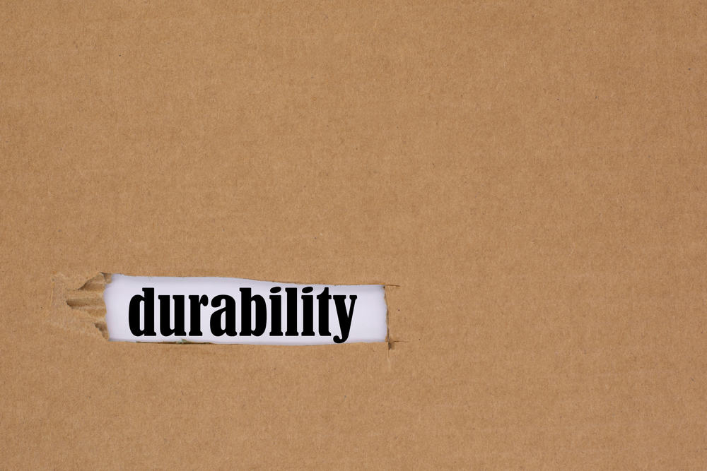 The word durability is written in a hole in the cardboard