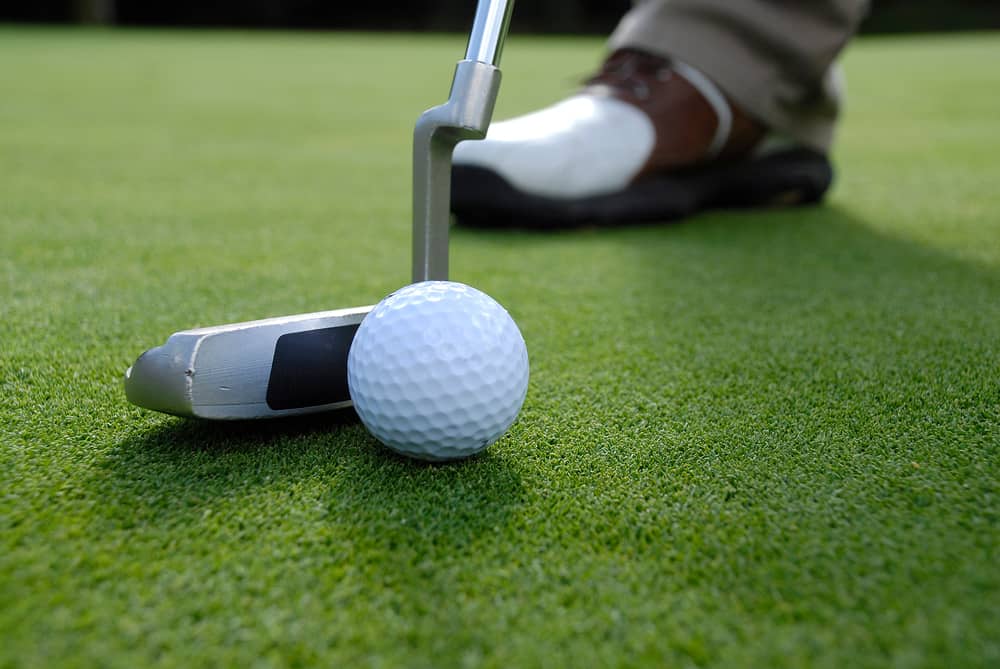 close up of a putt hitting a golf ball