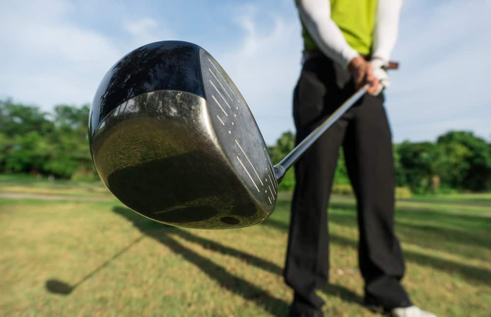 golfer prepare swing golf ball by club driver