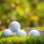Close up view of golf ball on tee on golf course