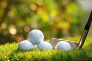 Close up view of golf ball on tee on golf course