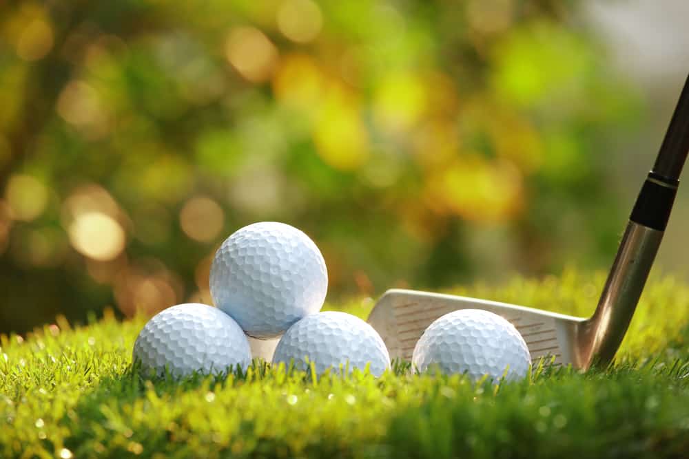Close up view of golf ball on tee on golf course