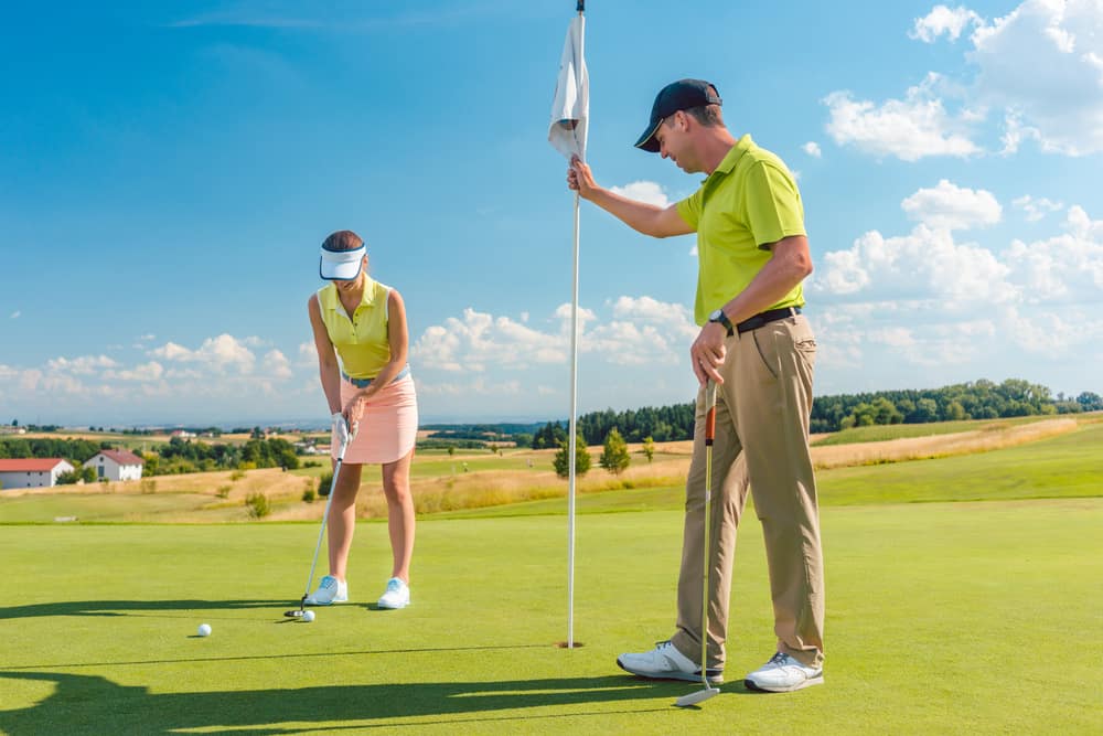 Female golf player ready to hit the ball