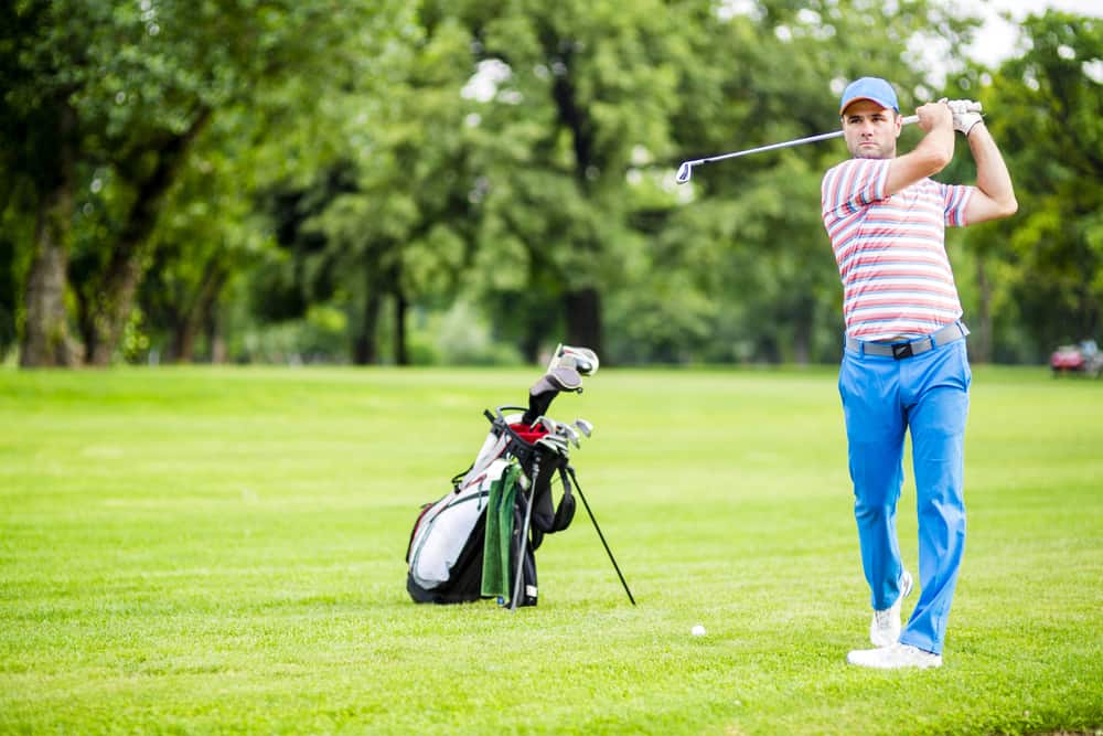 Golfer practicing and concentrating before and after shot during a nice sunny day