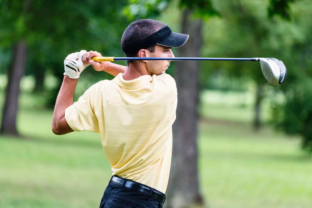 Male golfer teeing off