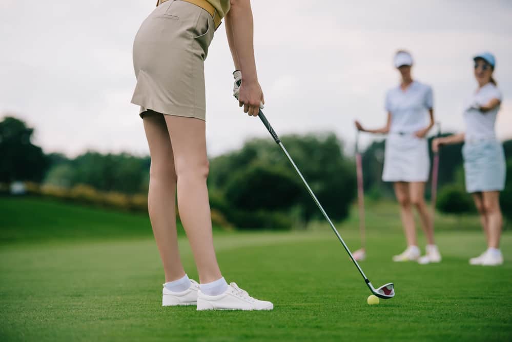 Partial view of woman playing golf with friends 