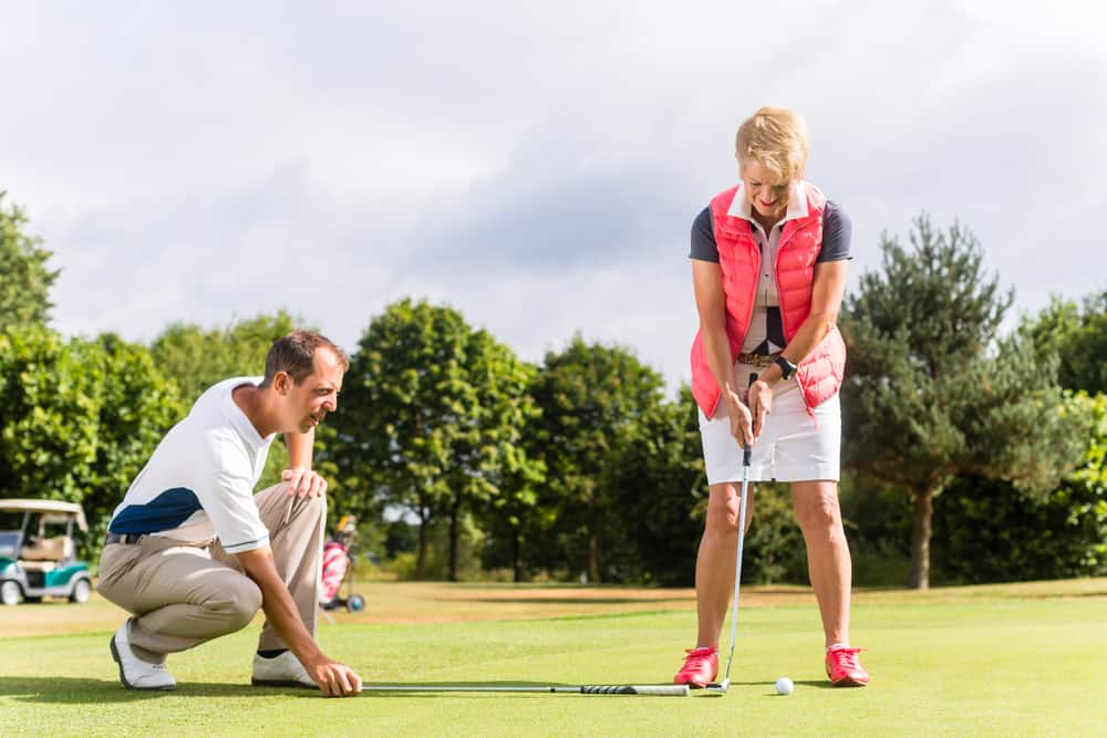 Senior woman and golf pro