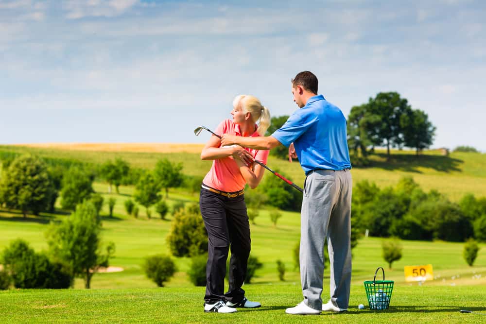 Young female golf player on course