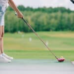 female player with golf club