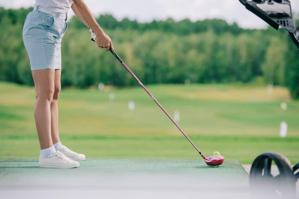  female player with golf club