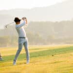 man golfer playing golf with friend at golf course