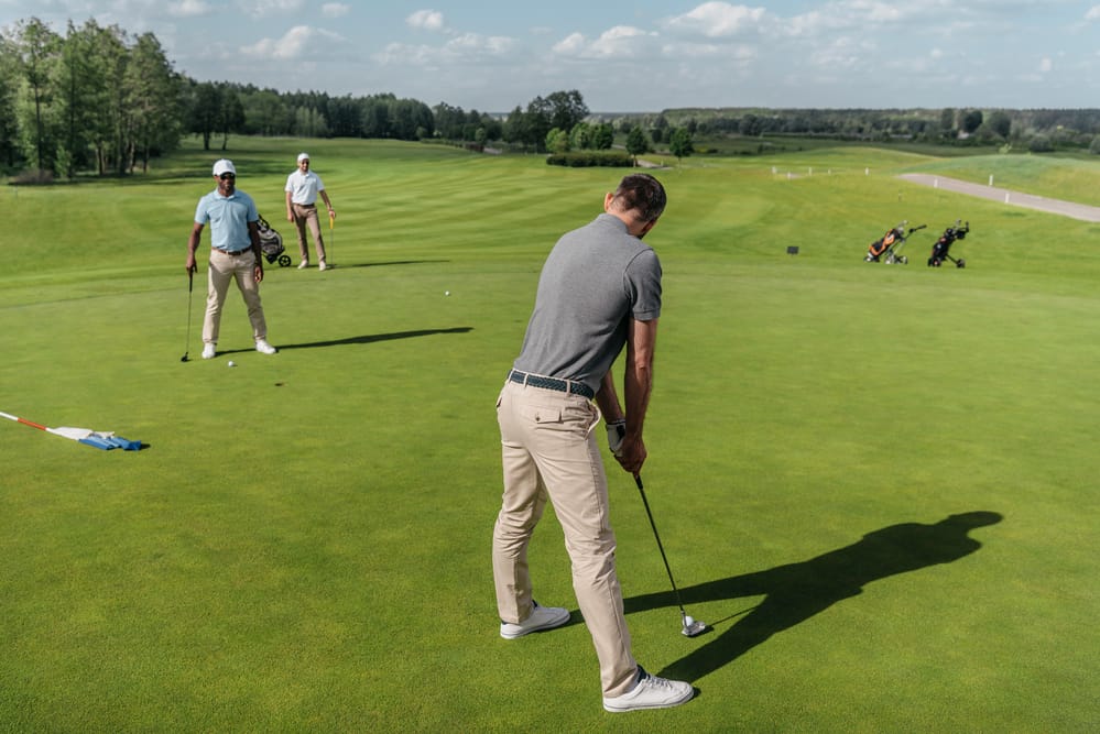 Casual men playing golf