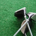 Crossed golfclubs at a drivingrange