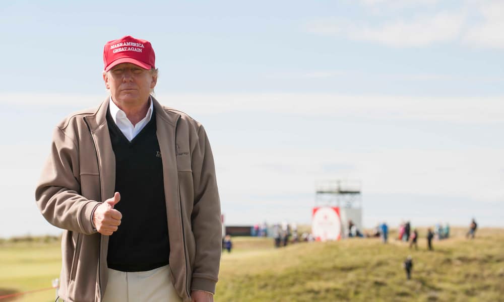 Donald Trump watches the action on course