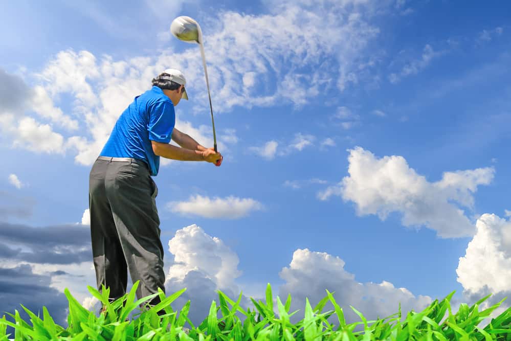 Golfer swinging his gear and hit the golf ball