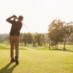 Male Golfer Lining Up Tee Shot