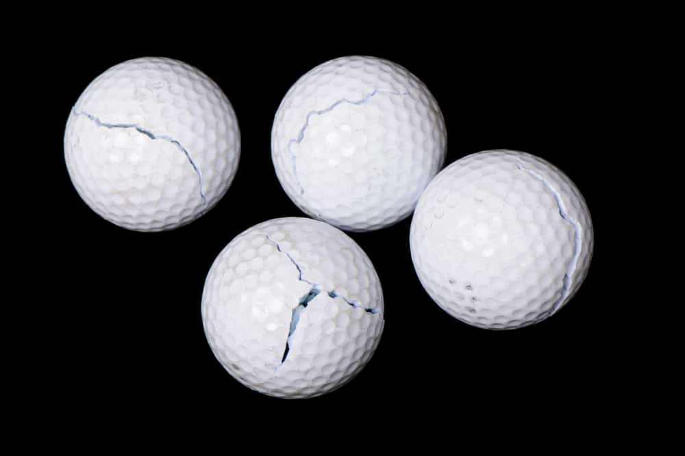 cracked golf balls, isolated on black background