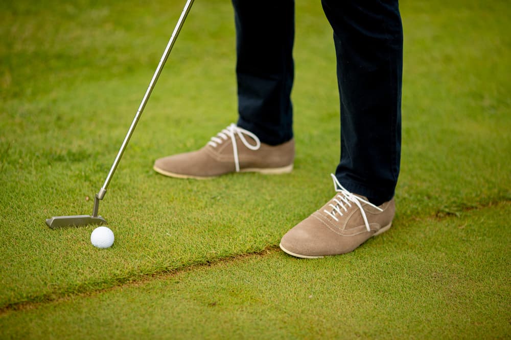 Closeup of young man legs playing golf