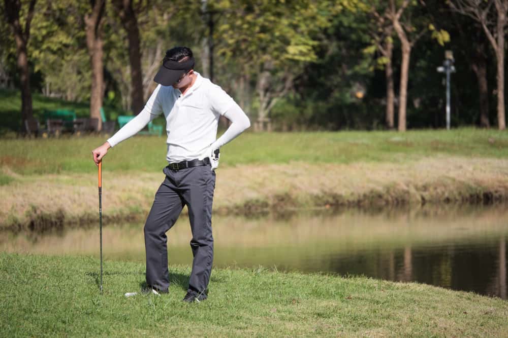 Frustrated golf player standing on the golf course