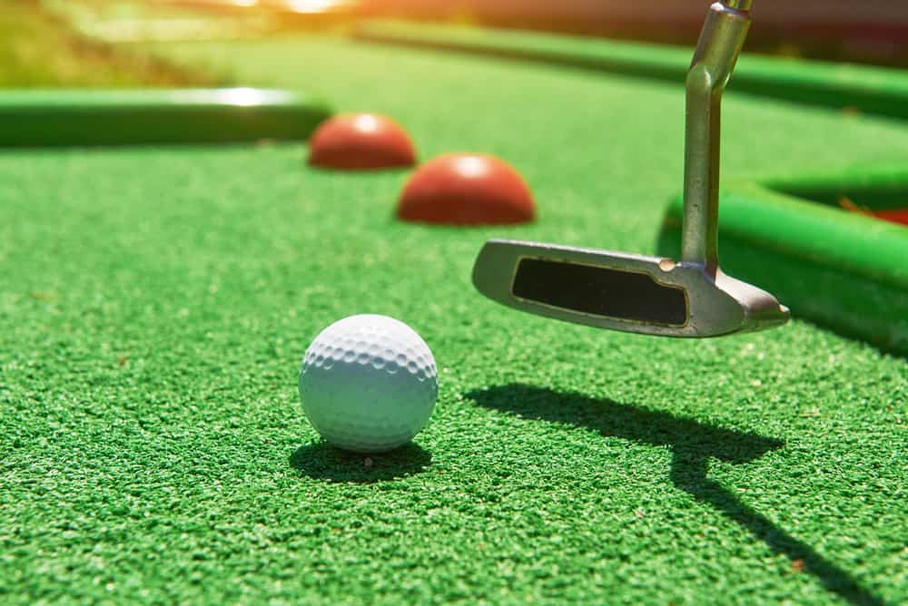 Golf ball and Golf putter on Artificial Grass