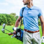 Golfer carrying golf bag