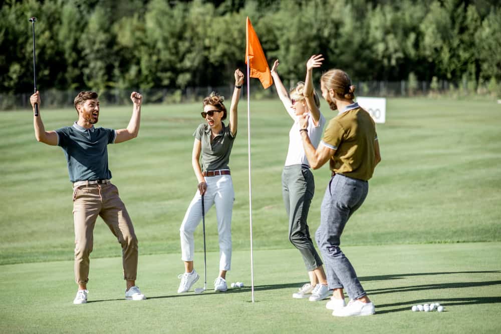 Group of a young friends playing golf