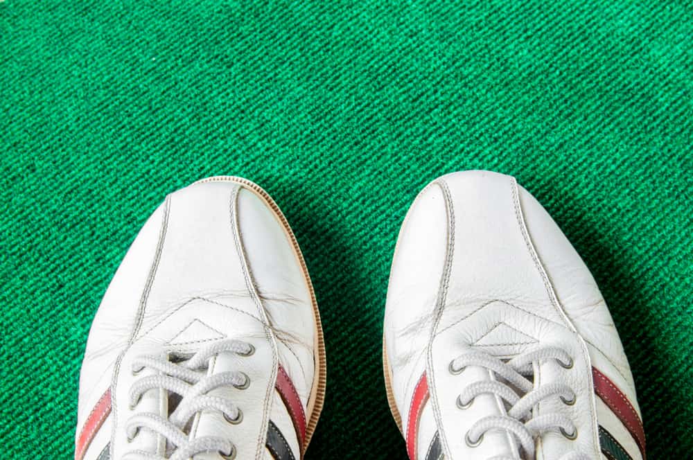 Leather golf shoe on green mat
