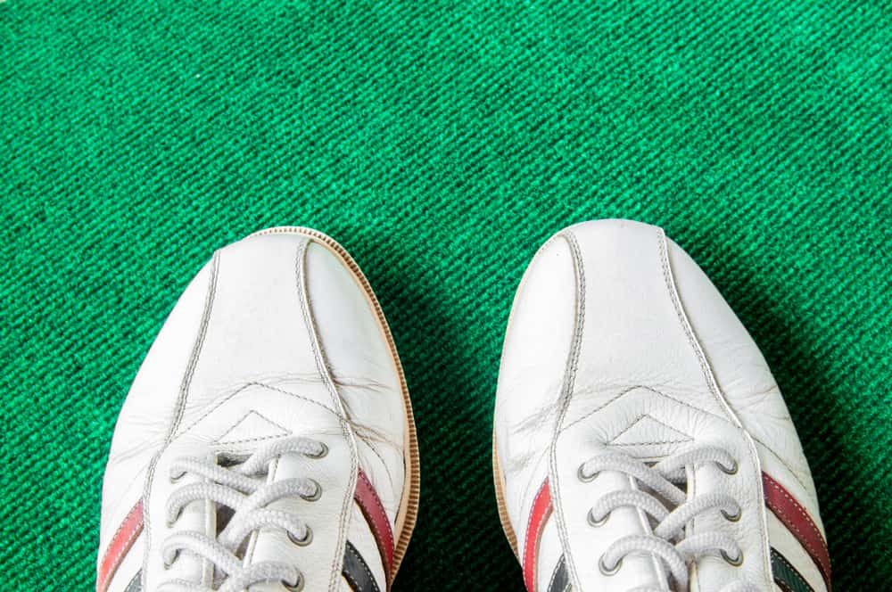 Leather golf shoe on green mat