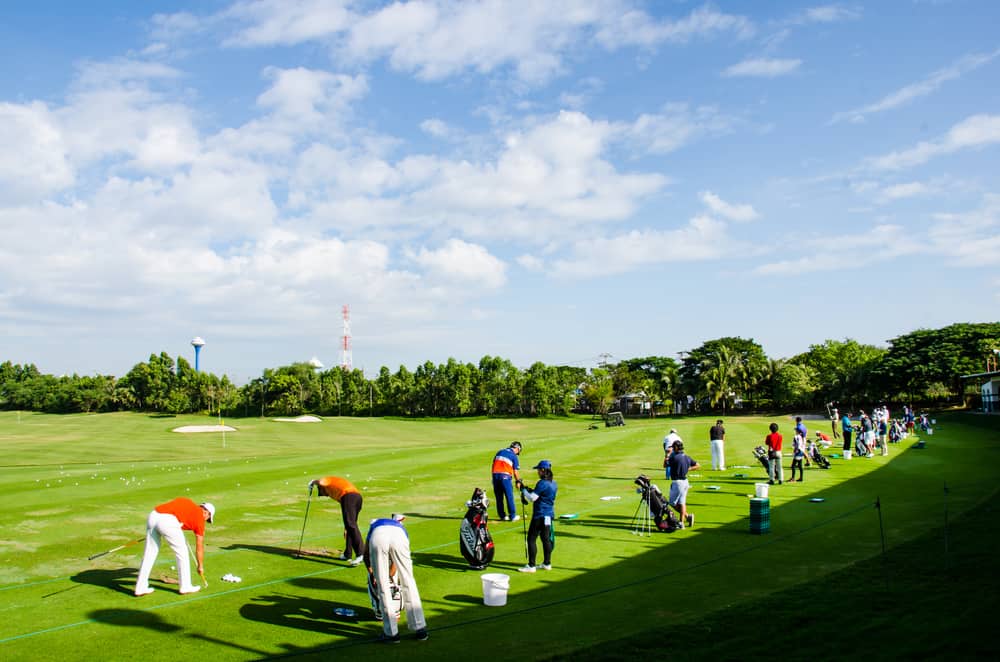 Players golf driving before the match